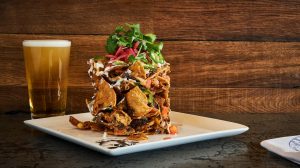 Trash can nachos and a glass of beer from Guy Fieri's Vegas Kitchen and Bar in LINQ Hotel + Experience