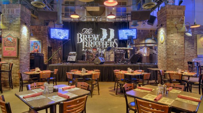 Interior of Brew Brothers with stage and dining area.