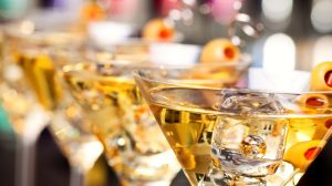 Row of martinis with olives.
