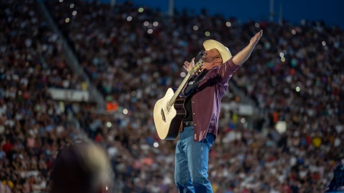 Garth Brooks with his guitar live on stage