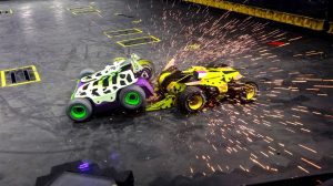 Green and White Tank attacking a Yellow Tank at Battle Bots at Horseshoe Las Vegas. Sparks Flying in the air during the attack.