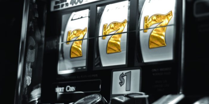 Black And White Image Of A Slot Machine Wheel Showing Triple Sevens In Gold Inside Bally's Las Vegas Casino