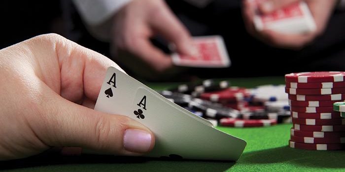 Photo of Person Holding Two Aces