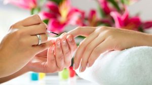 Woman Painting Another Woman's Nails Woman Painting Another Woman's Nails