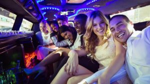 A group of people riding in a limousine. A group of people riding in a limousine.