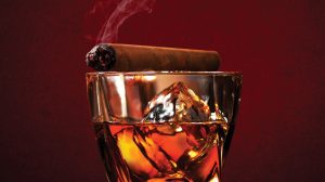 Montecristo Cigar Bar drink and lit cigar with smoke