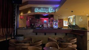 People sitting at the bar cheering. People sitting at the bar cheering.