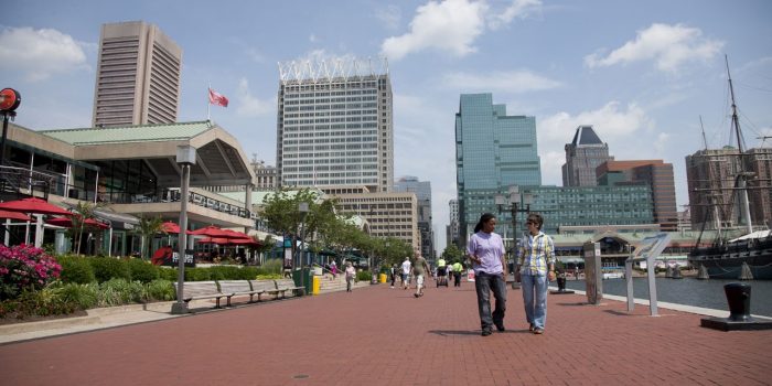 Photo Of Buildings And People Walking On the Boardwalk