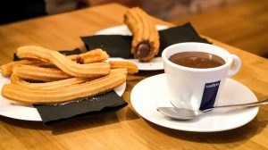 cup of Lavazza coffee with churros