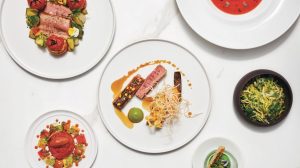 Multiple plates against a white background at Guy Savoy in Caesars Palace Las Vegas.