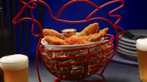 Fried chicken with a side of dip and two pints of beer.